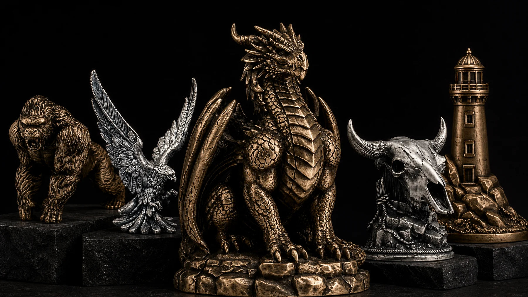 Bronze and silver collectible statues displayed on black stone plinths